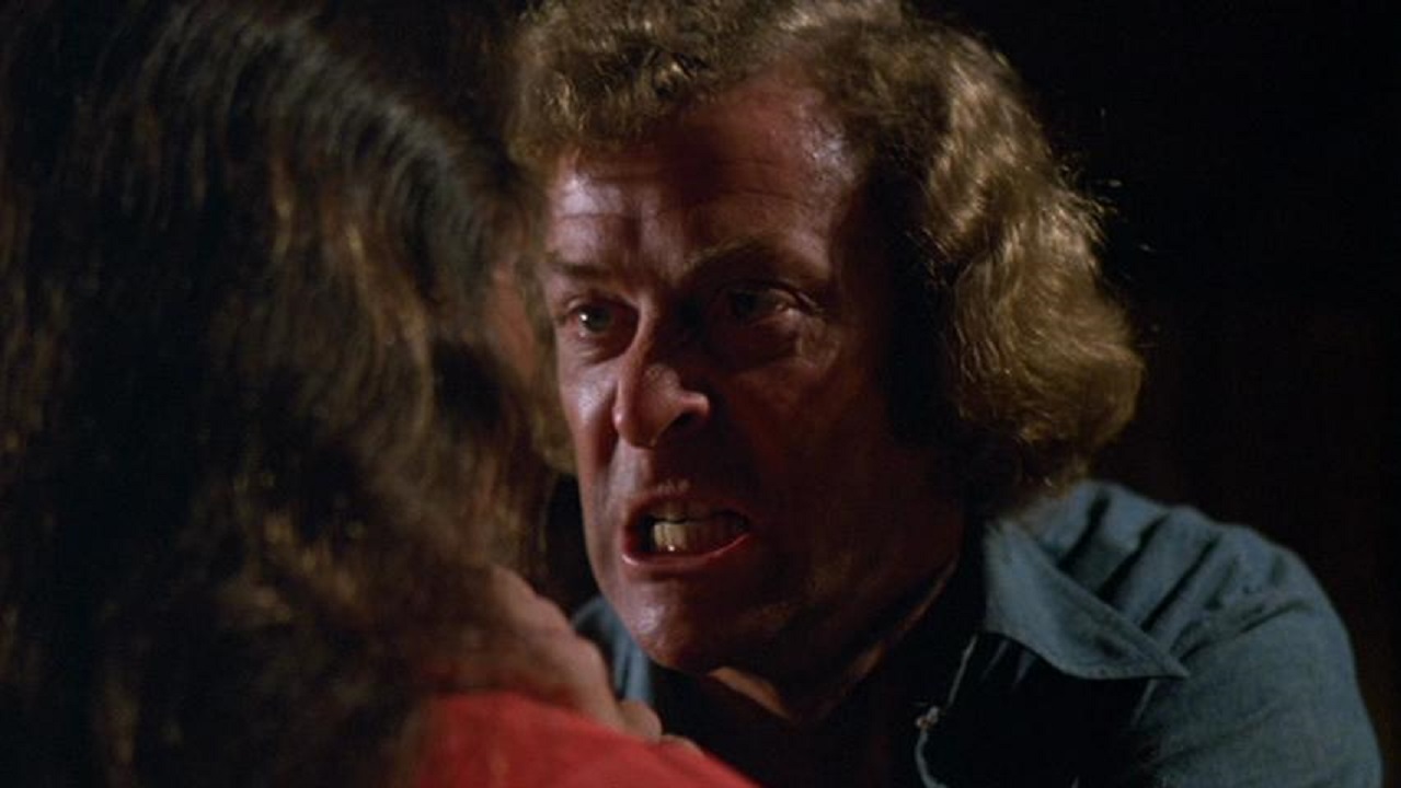 A maddened Jonathan Lansdale (Michael Caine) threatens girlfriend Andrea Marcovicci in The Hand (1981)