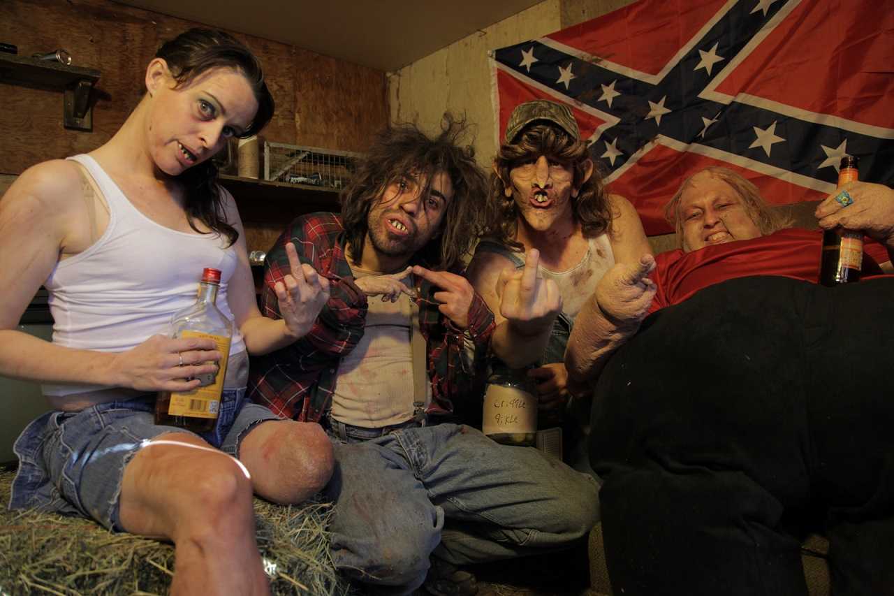 Hans Crippleton (Kevon Ward) surrounded by his in-bred family One-Legged Sis (Katie Bevard), Cousin Bumpkin (Heath Heine) and Mama (Irene Leonard) in Hans Crippleton: Talk to the Hans (2014)