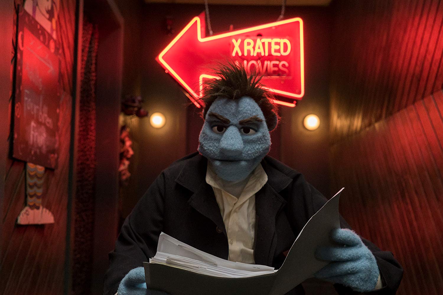 Phil investigates clues at a puppet porn store in The Happytime Murders (2018)