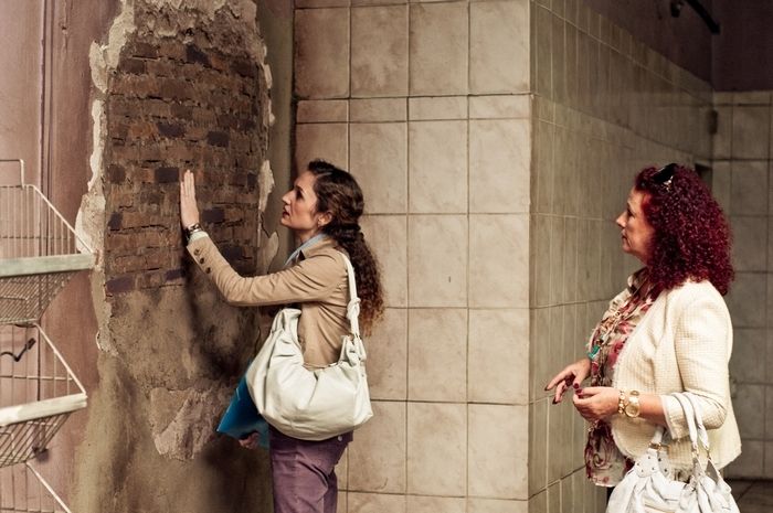 (l to r) The supermarket's new owner Helena Albergaria and Lilian Blanc examine the damp spot on the wall in Hard Labor (2011)