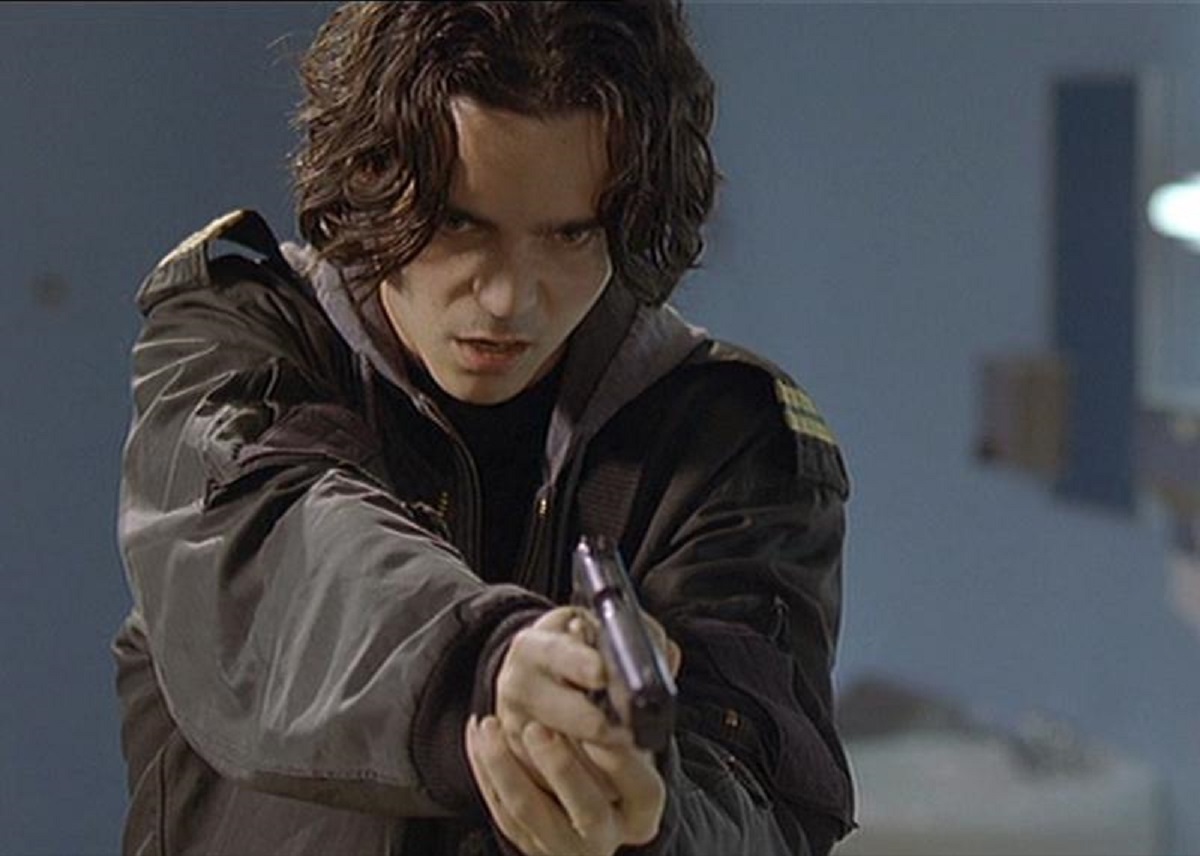 Kett Turton wields gun in Heart of America: Home Room (2002)