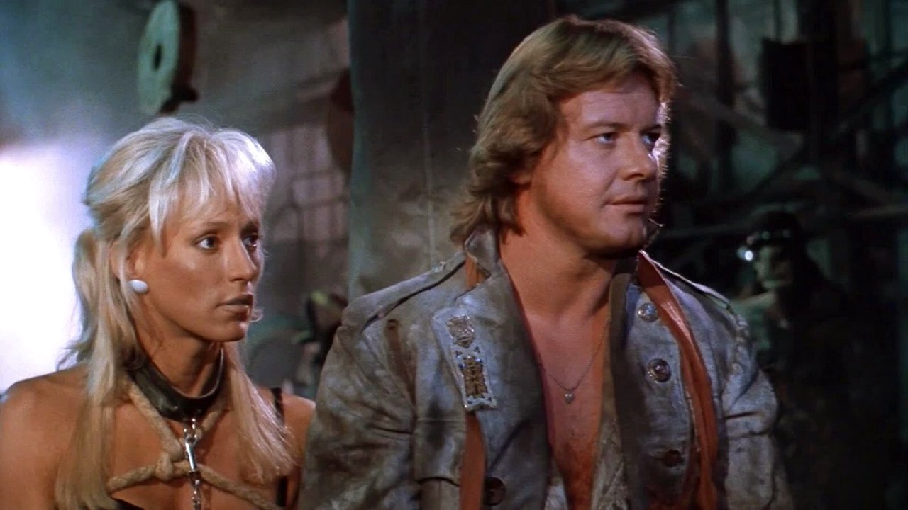 Sam Hellmond (Roddy Piper) and Nurse Spangle (Sandahl Bergman) in Hell Comes to Frogtown (1987)