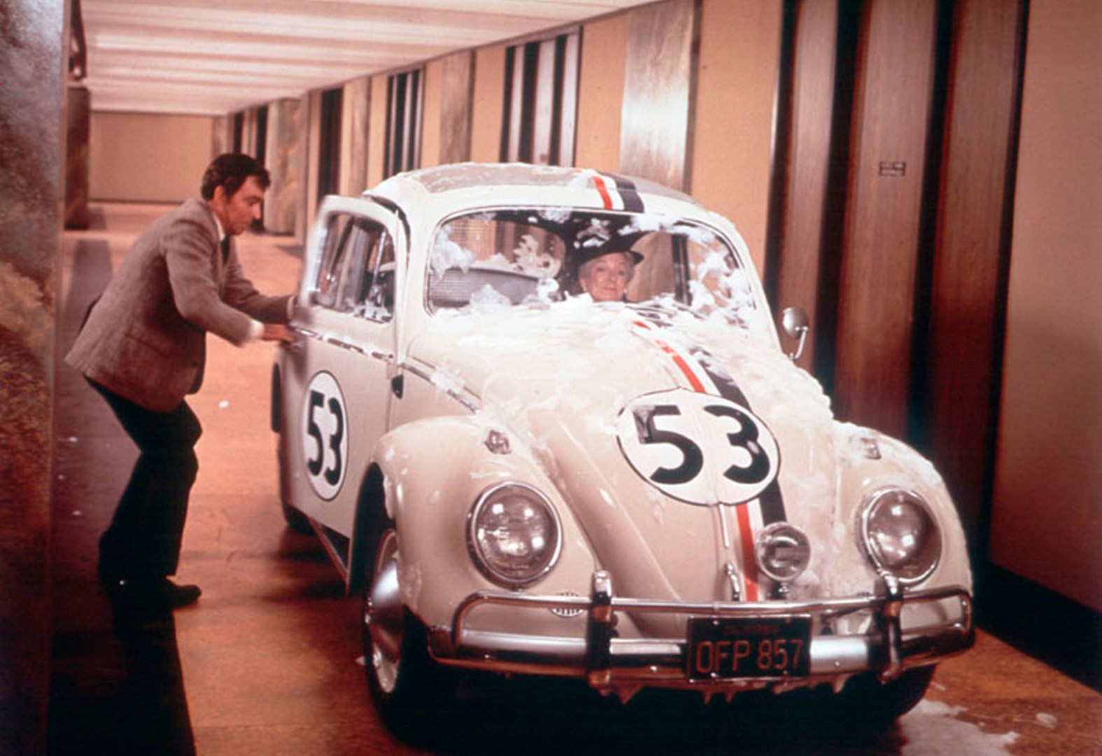 Ken Berry joins Helen Hayes as Herbie drives through the hallways of an office building in Herbie Rides Again (1974)