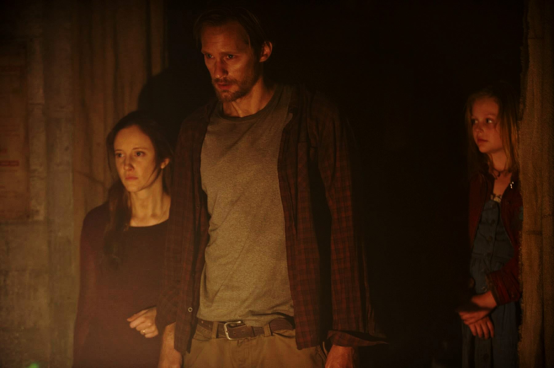 Fallout shelter family - (l to r) Andrea Riseborough, Alexander Skarsgård and Emily Alyn Lynd in Hidden (2015)