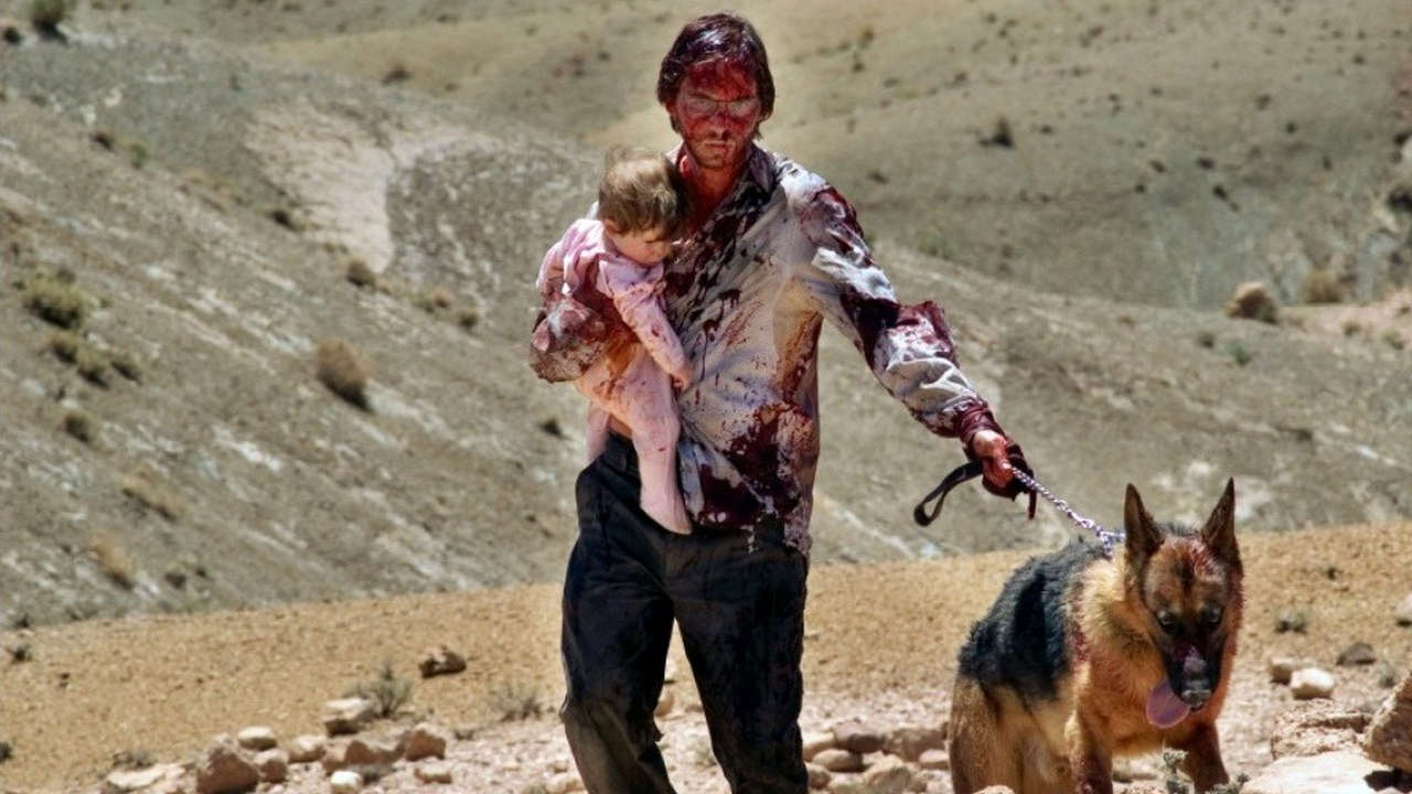 Aaron Stanford with baby and dog under assault in the New Mexico desert in The Hills Have Eyes (2006)