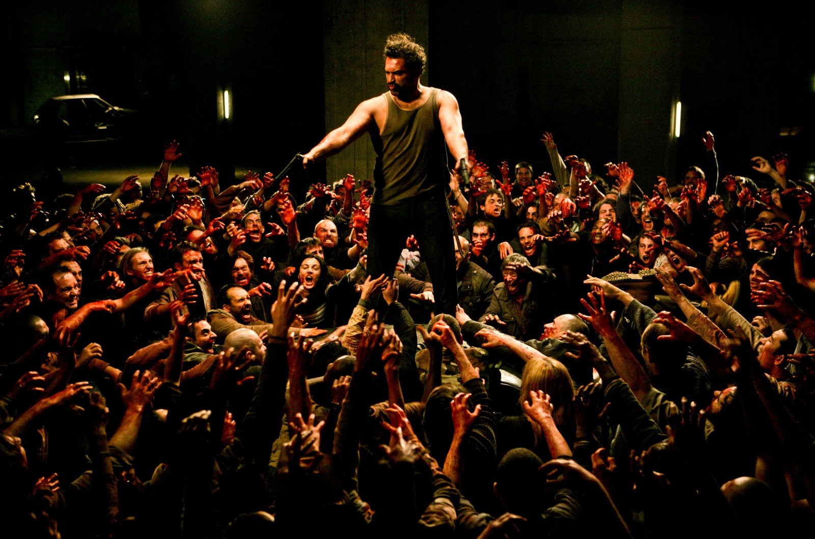 Jean-Pierre Martins surrounded by a horde of zombies in a parking garage in The Horde (2009)