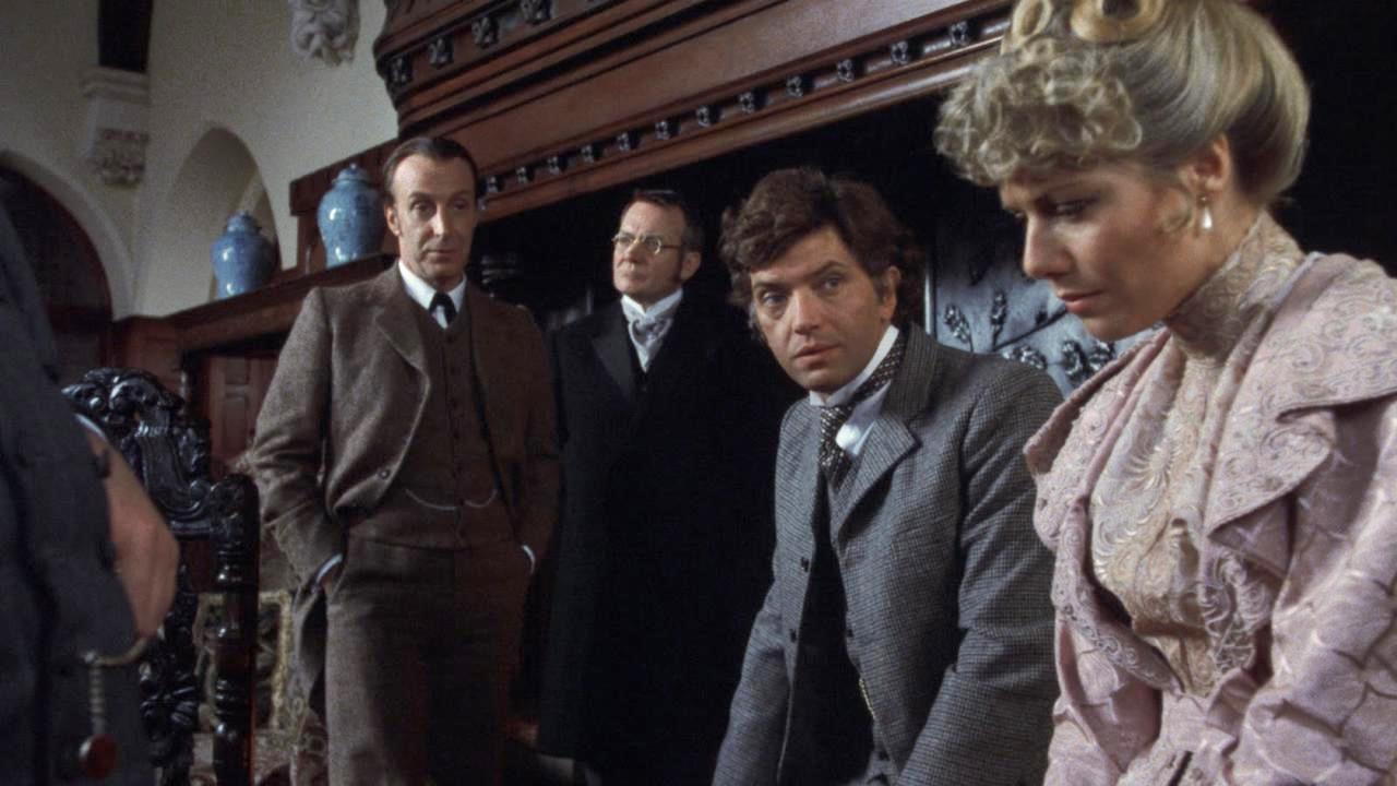 Sherlock Holmes (Ian Richardson), Dr Mortimer (Denholm Elliott), Sir Henry Baskerville (Martin Shaw) and Beryl Stapleton (Glynis Barber) in The Hound of the Baskervilles (1983)