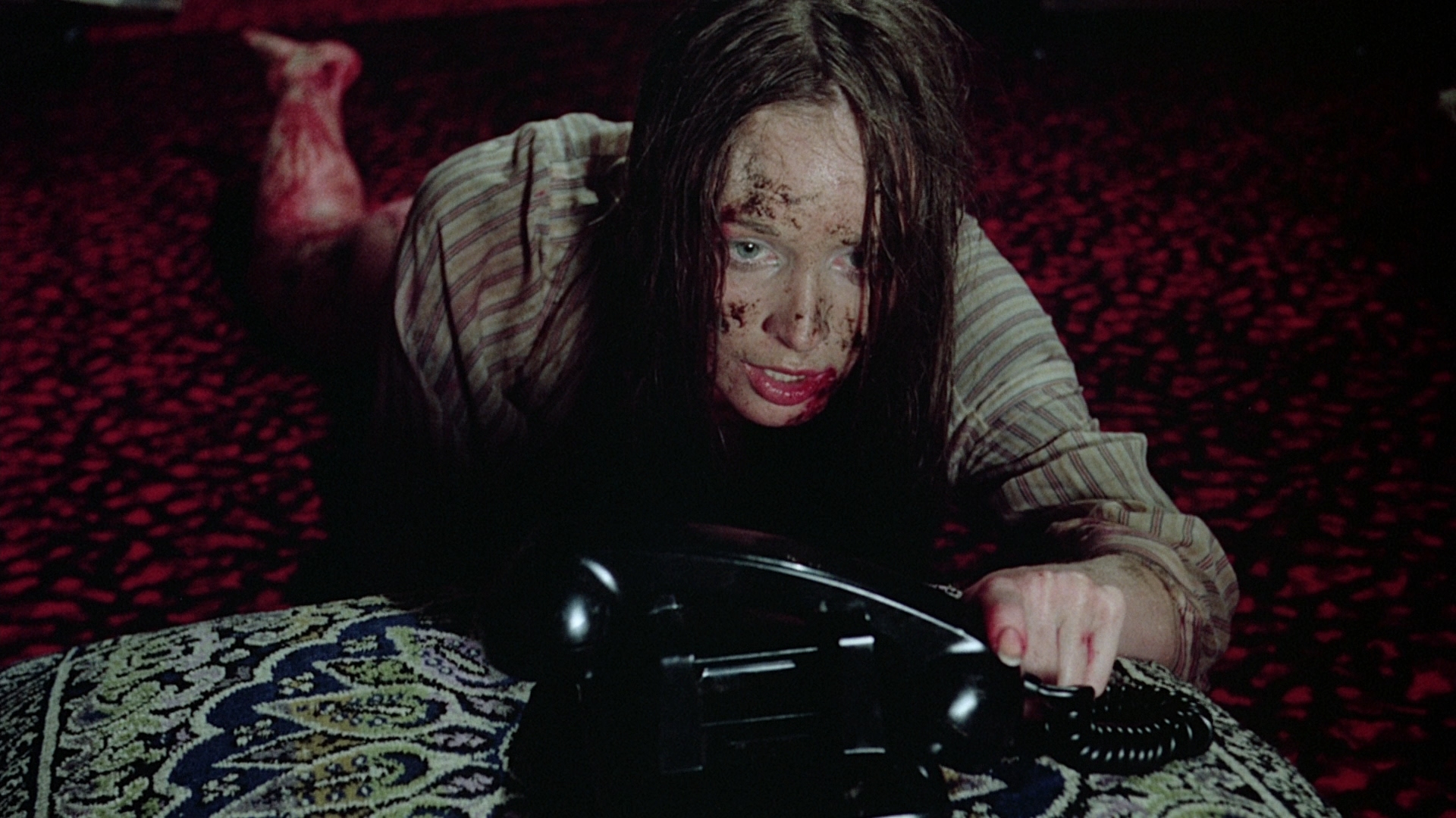 A raped Jenny Hills (Camille Keaton) crawls to the phone in I Spit on Your Grave (1978)