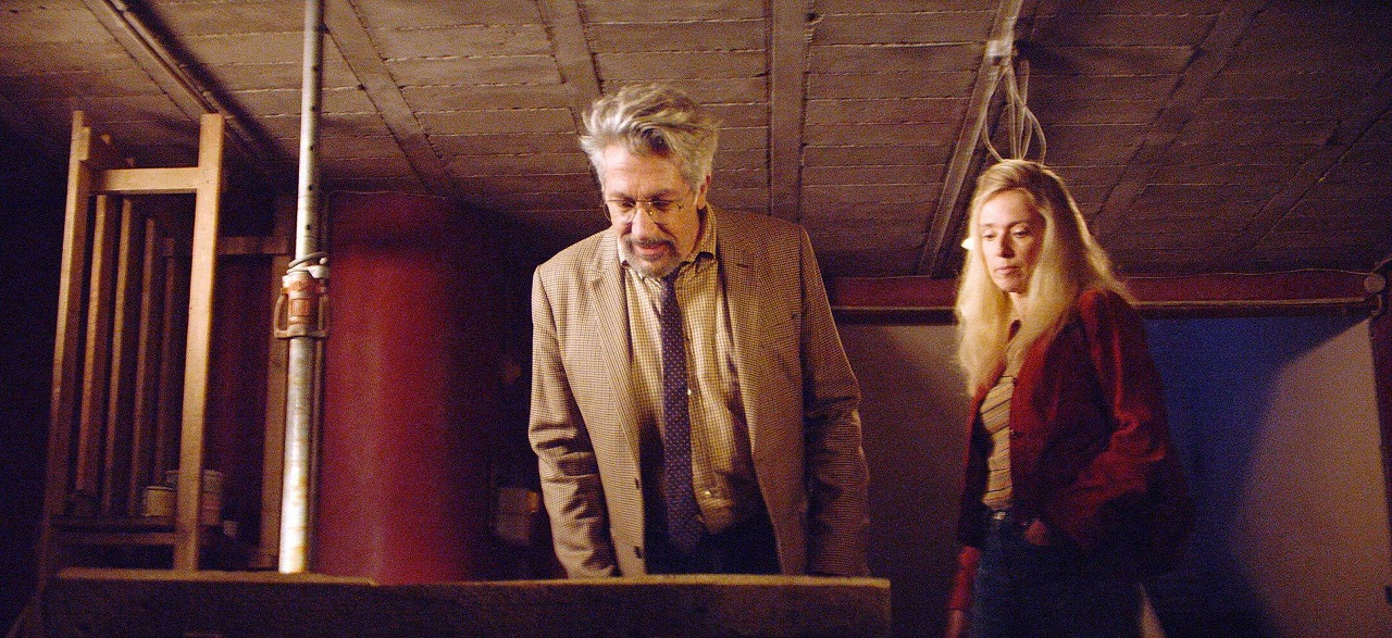 Alain Chabat and Lea Drucker examine the portal in the basement in Incredible But True (2022)