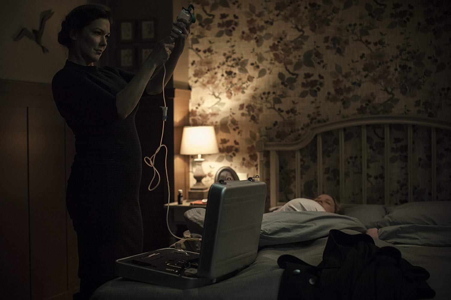 Laura Harring prepares to operate on a sleeping Rachel Nichols in Inside (2016)