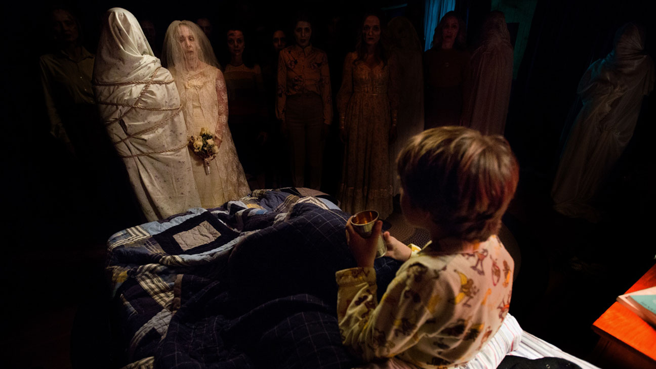 Ty Simpkins surrounded by ghosts in Insidious Chapter 2 (2013)