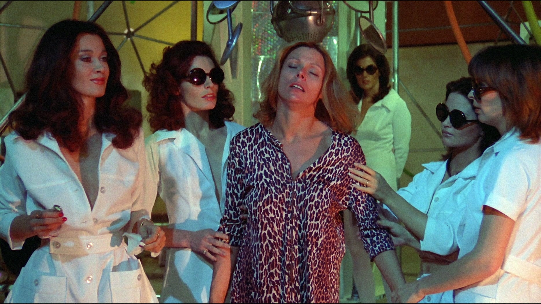 The bee women place a new recruit into the radiation machine in Invasion of the Bee Girls (1973)