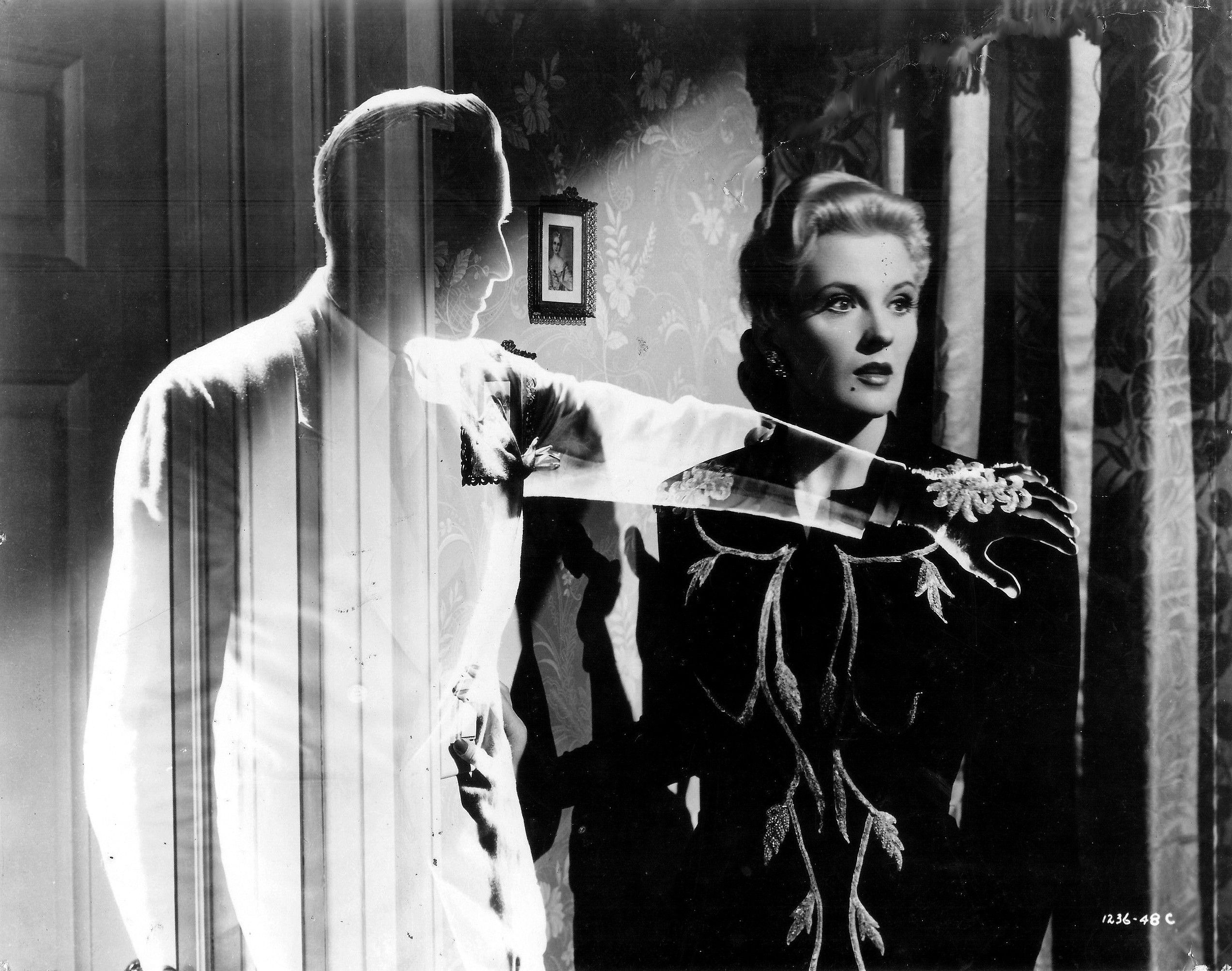 An invisible Jon Hall comforts Ilona Massey in Invisible Agent (1942)