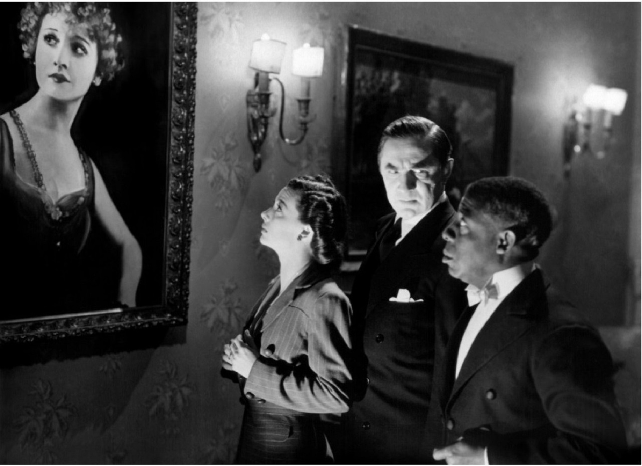 Polly Ann Young, Bela Lugosi and Clarence Muse look at Lugosi’s late wife’s portrait in The Invisible Ghost (1941)