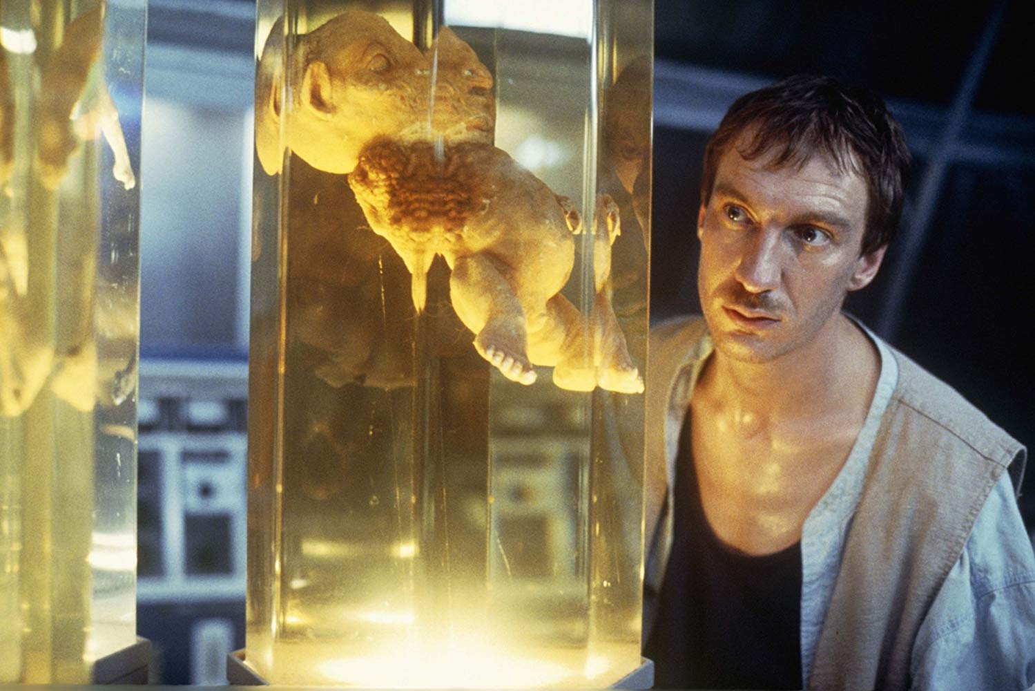 Castaway Edward Douglas (David Thewlis) views the experiments in the lab in The Island of Dr Moreau (1996)