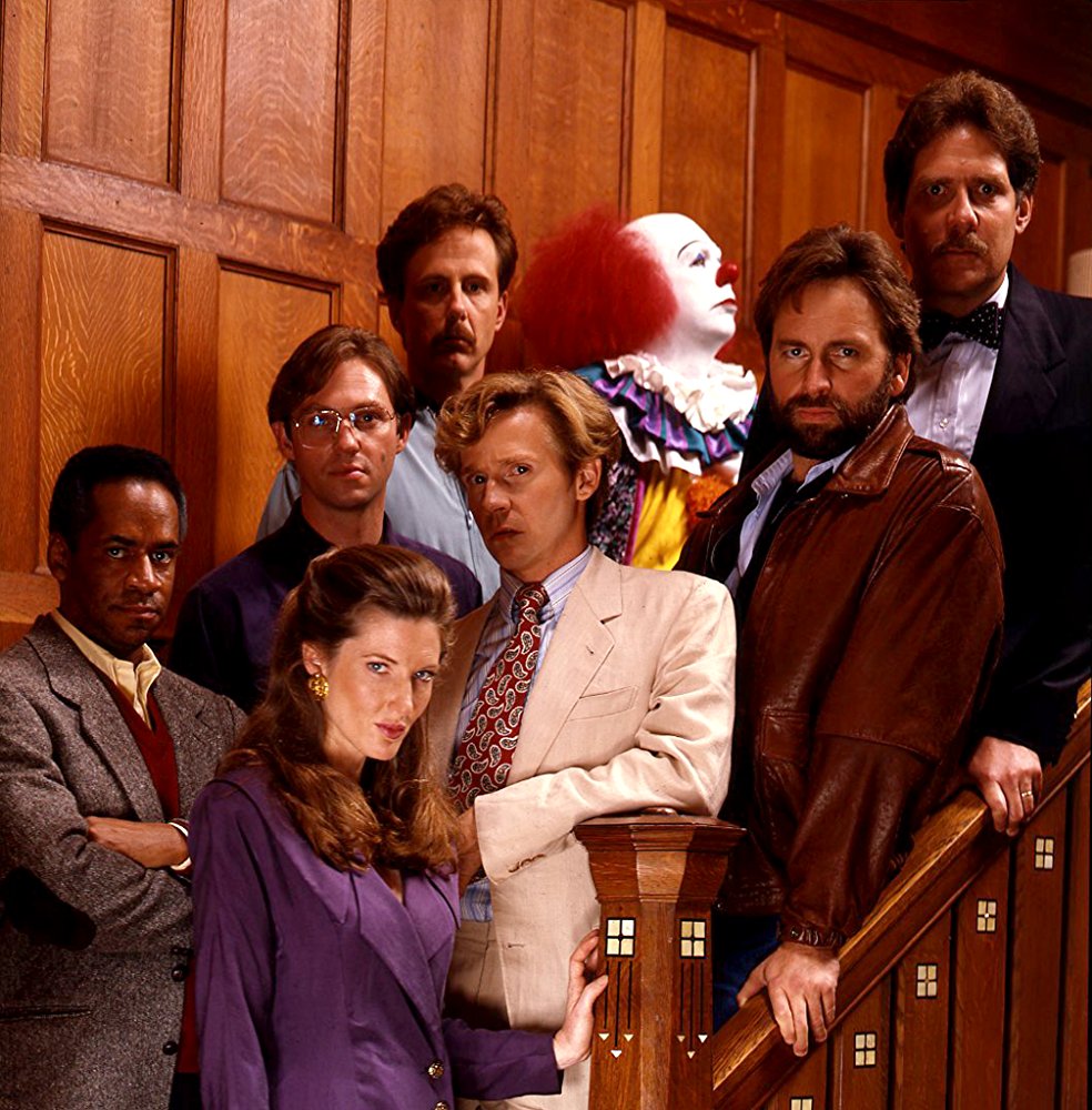 The grown-ups - (l to r) Tim Reid, Annette O'Toole, Richard Thomas, Harry Anderson, Dennis Christopher, Pennywise (Tim Curry), John Ritter, Richard Masur in It (1990)