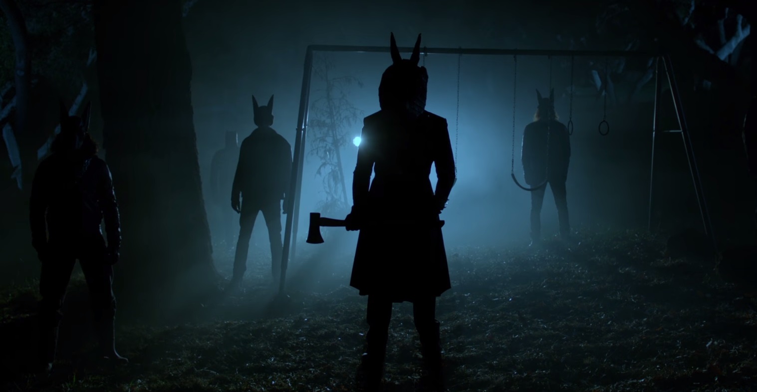 Masked cultists gather outside the house in Jackals (2017)