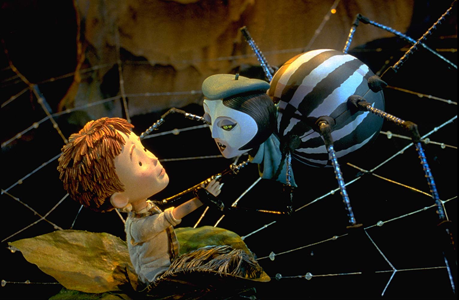 James (voiced by Paul Terry) and Spider (voiced by Susan Sarandon) in James and the Giant Peach (1996)