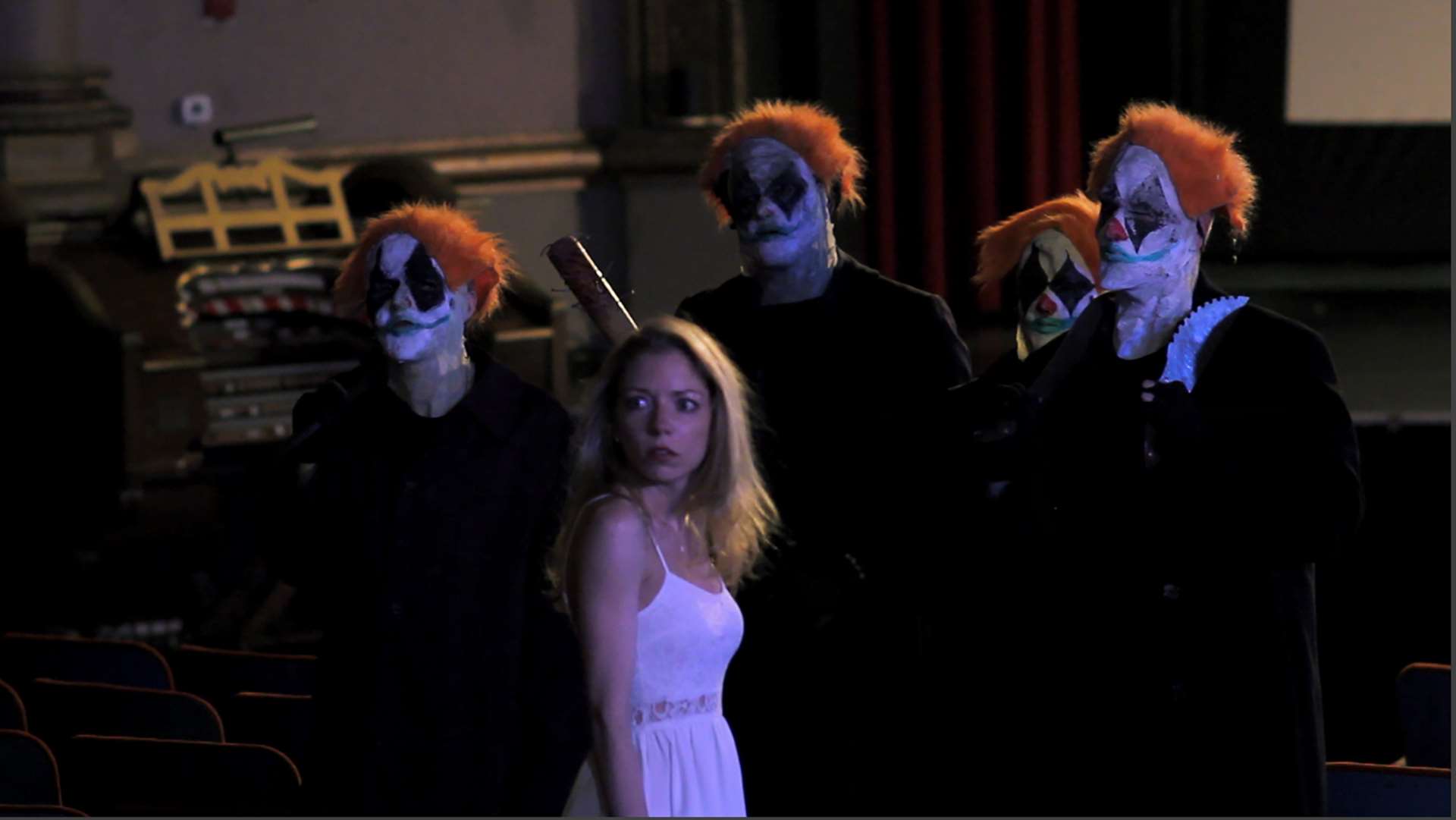 Heroine Aurora (Lacy Marie Meyer) surrounded by ghostly clowns in Joker's Wild (2016)