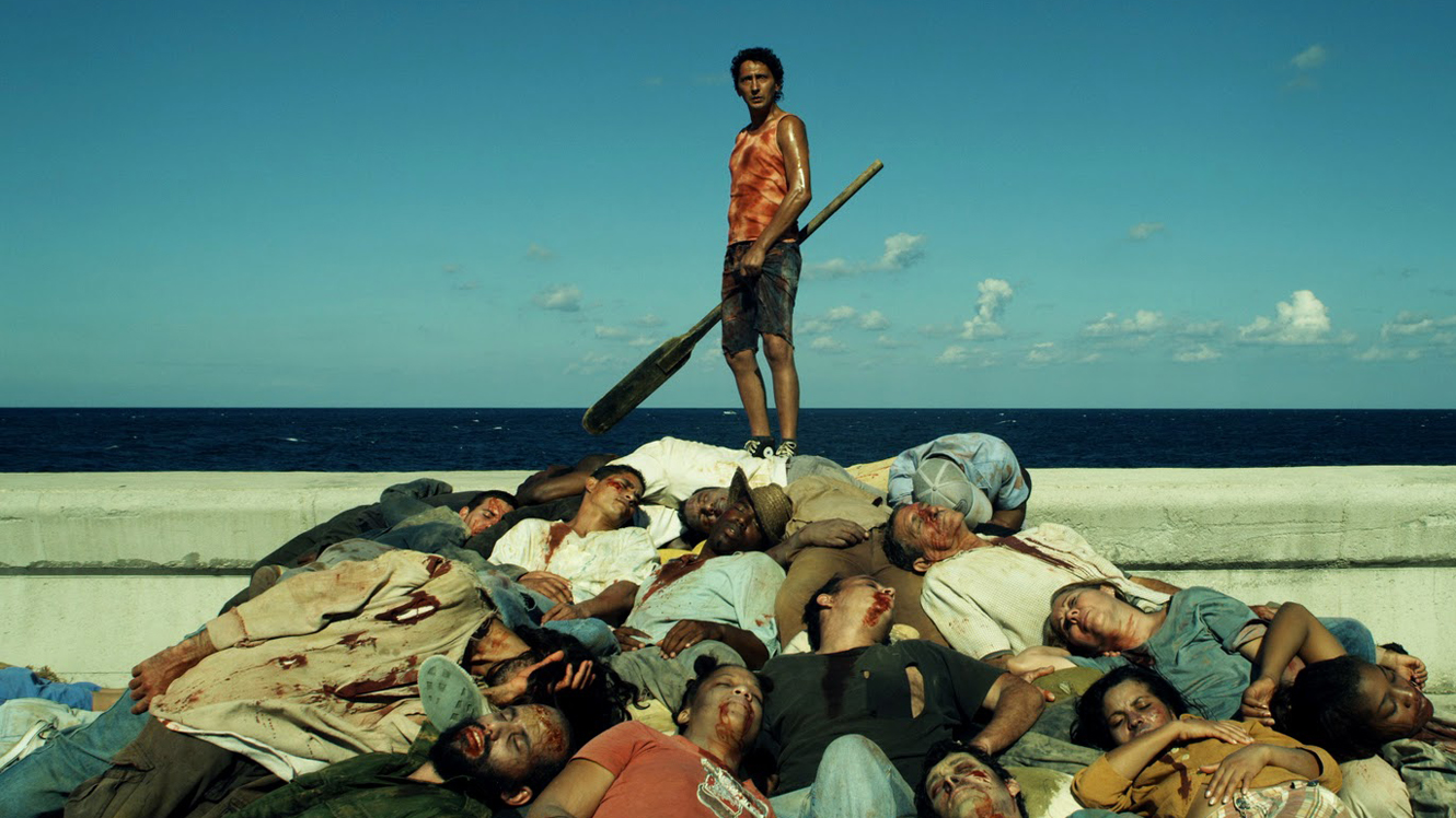 Juan (Alexis Diaz) at the head of a pile of zombies in Juan of the Dead (2011)