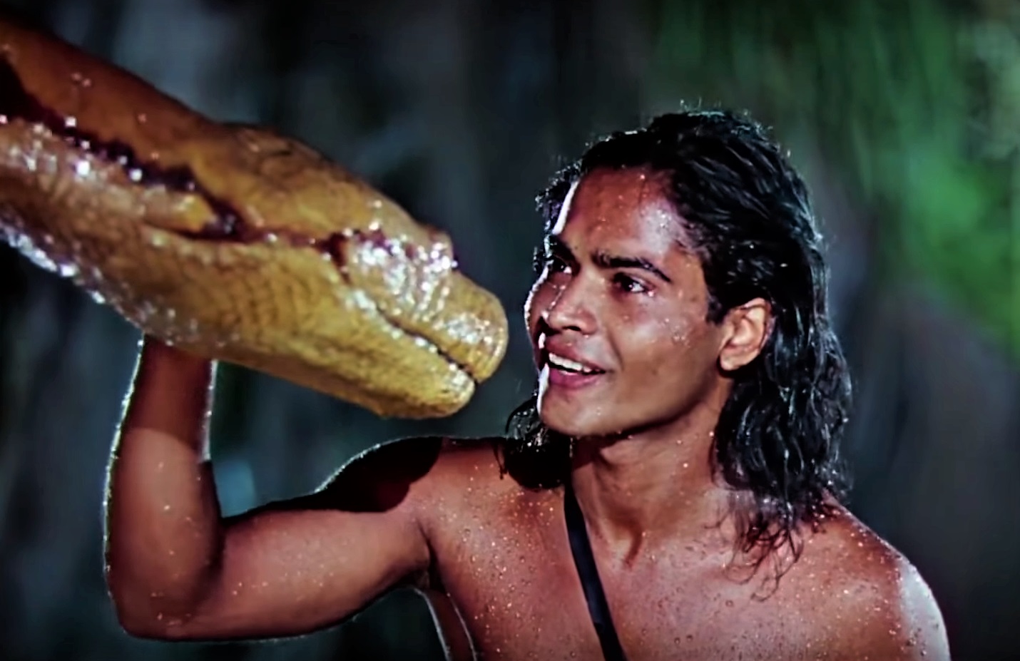 Mowgli (Sabu) and the snake Kaa in Jungle Book (1942)