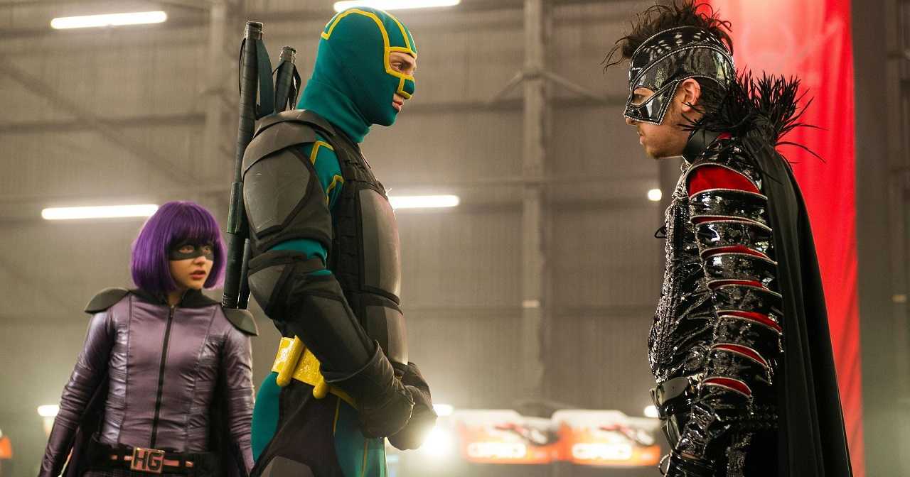 (l to r) Mindy Macready/Hit Girl (Chloe Grace Moretz) and Dave Lizewski/Kick-Ass (Aaron Taylor-Johnson) up against villain Chris D’Amico/The Mother Fucker (Christopher Mintz-Plasse) in Kick-Ass 2 (2013)