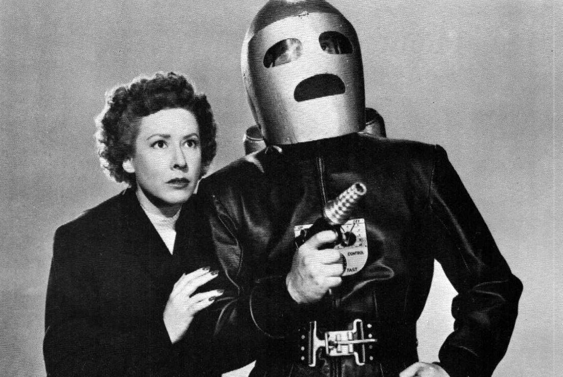 Jeff King in his guise as the Rocket Man (Tristram Coffin) and girlfriend Glenda Thomas (Mae Clarke) in King of the Rocket Men (1949)