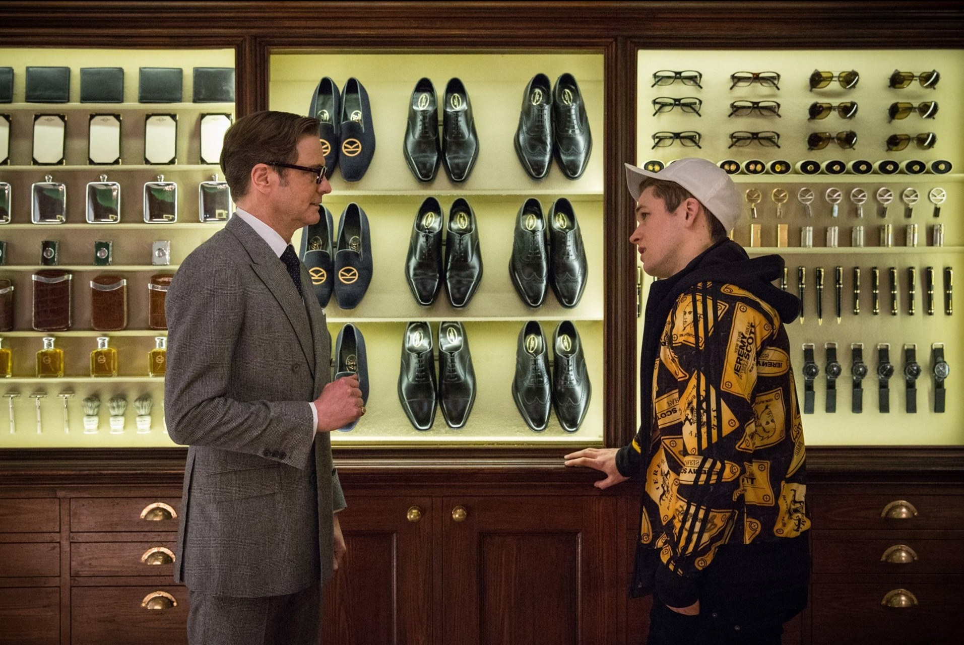 (l to r) Harry Hart (Colin Firth) introduces Eggsy (Taron Egerton) to the Kingsmen in Kingsman: The Secret Service (2015)