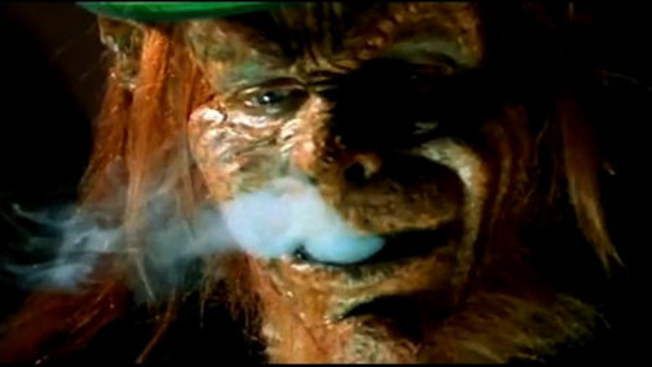 The Leprechaun (Warwick Davis) enjoys a spliff in Leprechaun in the Hood (2000)