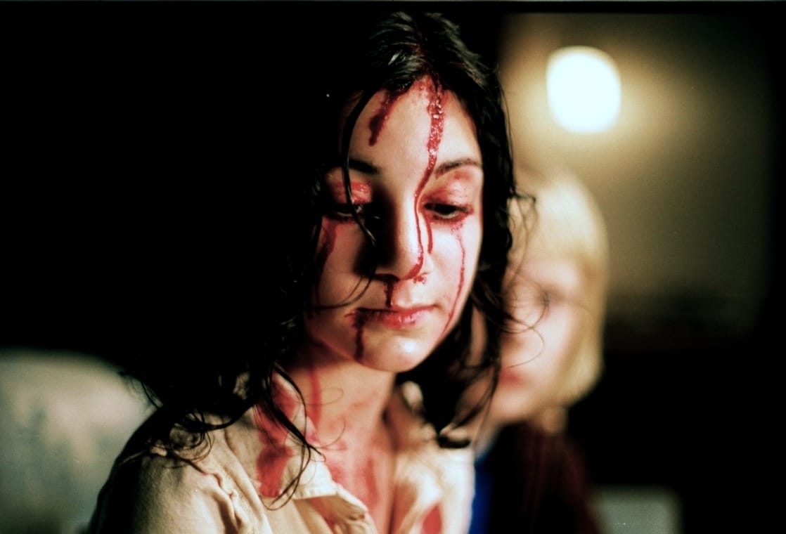 Lina Leandersson as Eli, the mystery girl next door that Oskar befriends in Let the Right One In (2008)