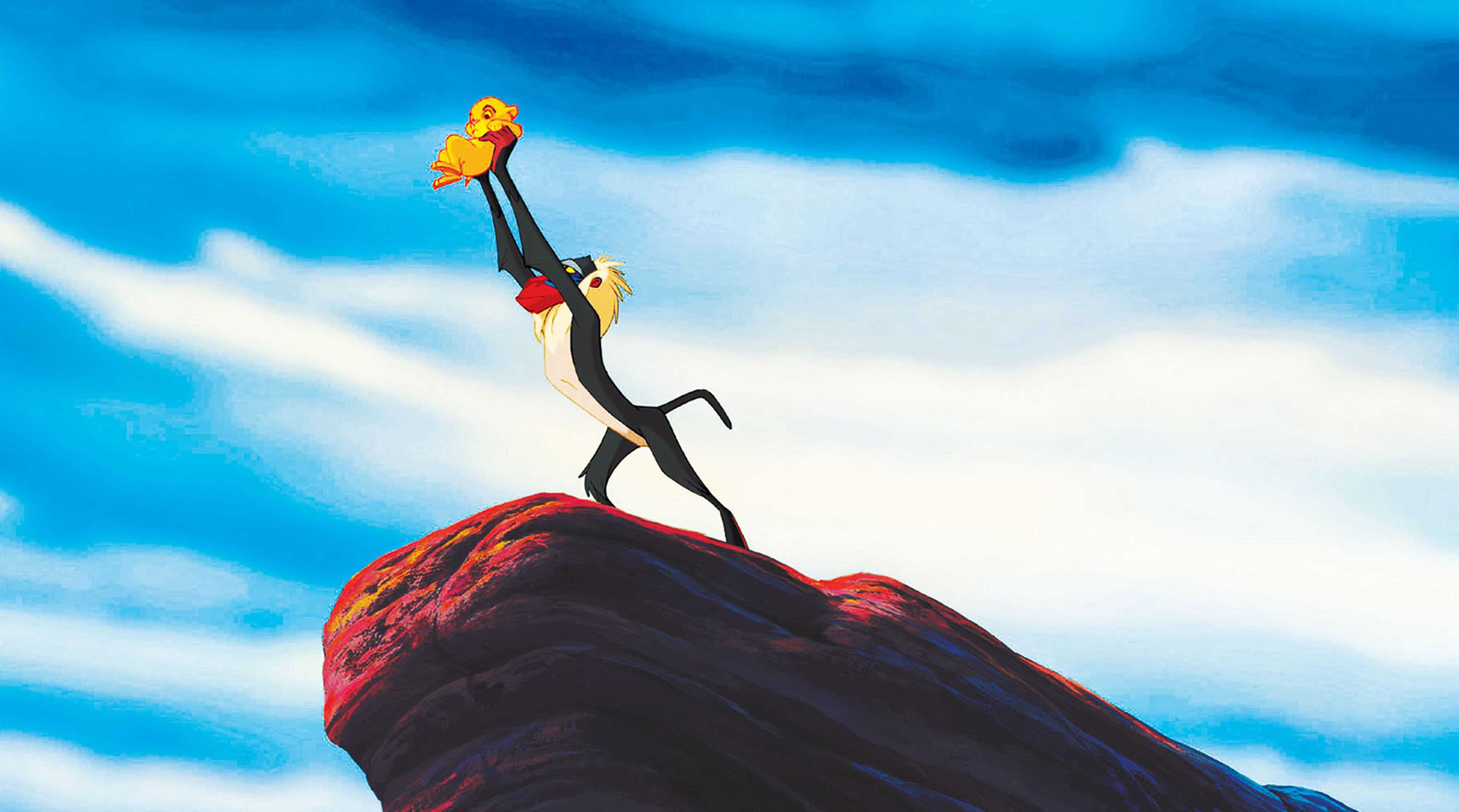 Rafiki holds the infant Simba up over Pride Rock in The Lion King (1994)