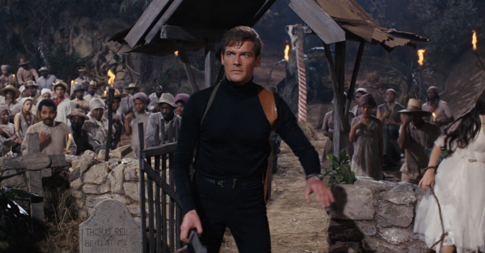 James Bond (Roger Moore) caught in the midst of a voodoo ceremony in Live and Let Die (1973)