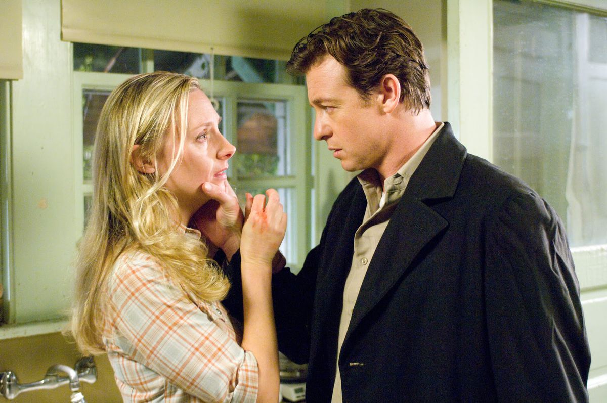 Hope Davis menaced by Simon Baker in The Lodger (2009)