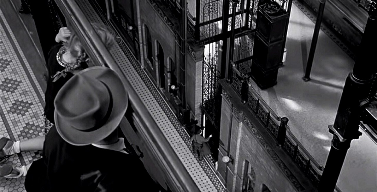 David Wayne and Janine Perreau look down into the atrium of The Bradbury Building in M (1951)