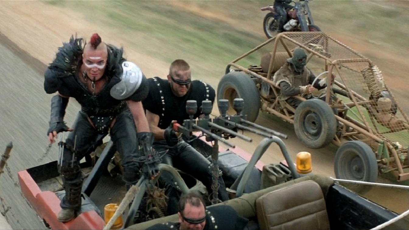 Wasteland crazies led by Wez (Vernon Wells) attempt to board the tanker in Mad Max 2 (1981)