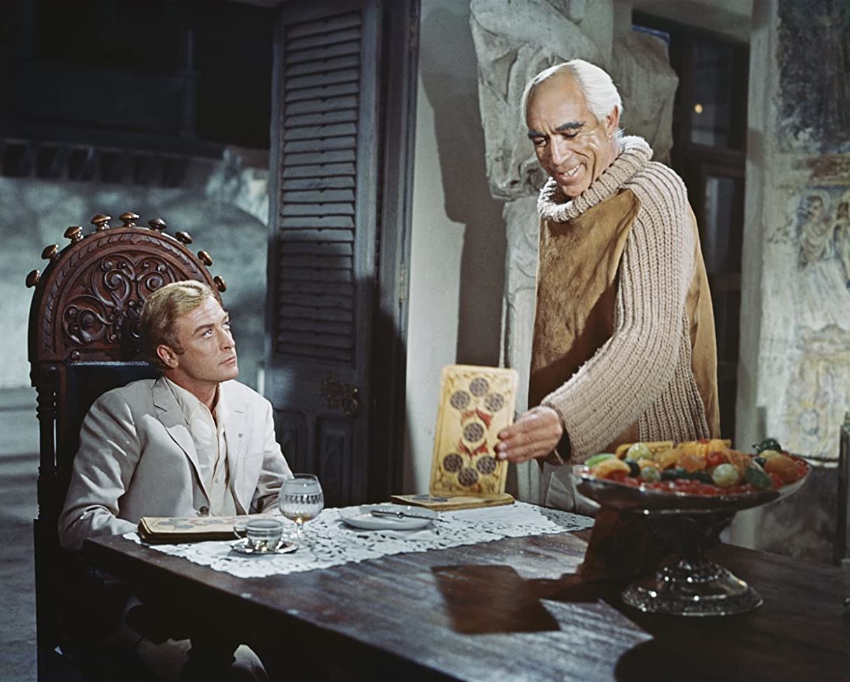 Nicholas Urfe (Michael Caine) at the centre of a series of reality games put on by Maurice Colchis (Anthony Quinn) in The Magus (1968)