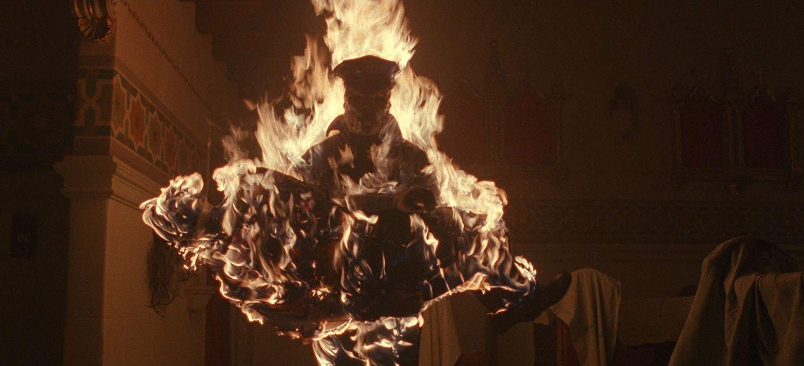 Matt Cordell (Robert Z'dar) carries off Gretchen Baker in flames in Maniac Cop 3 Badge of Silence (1992)