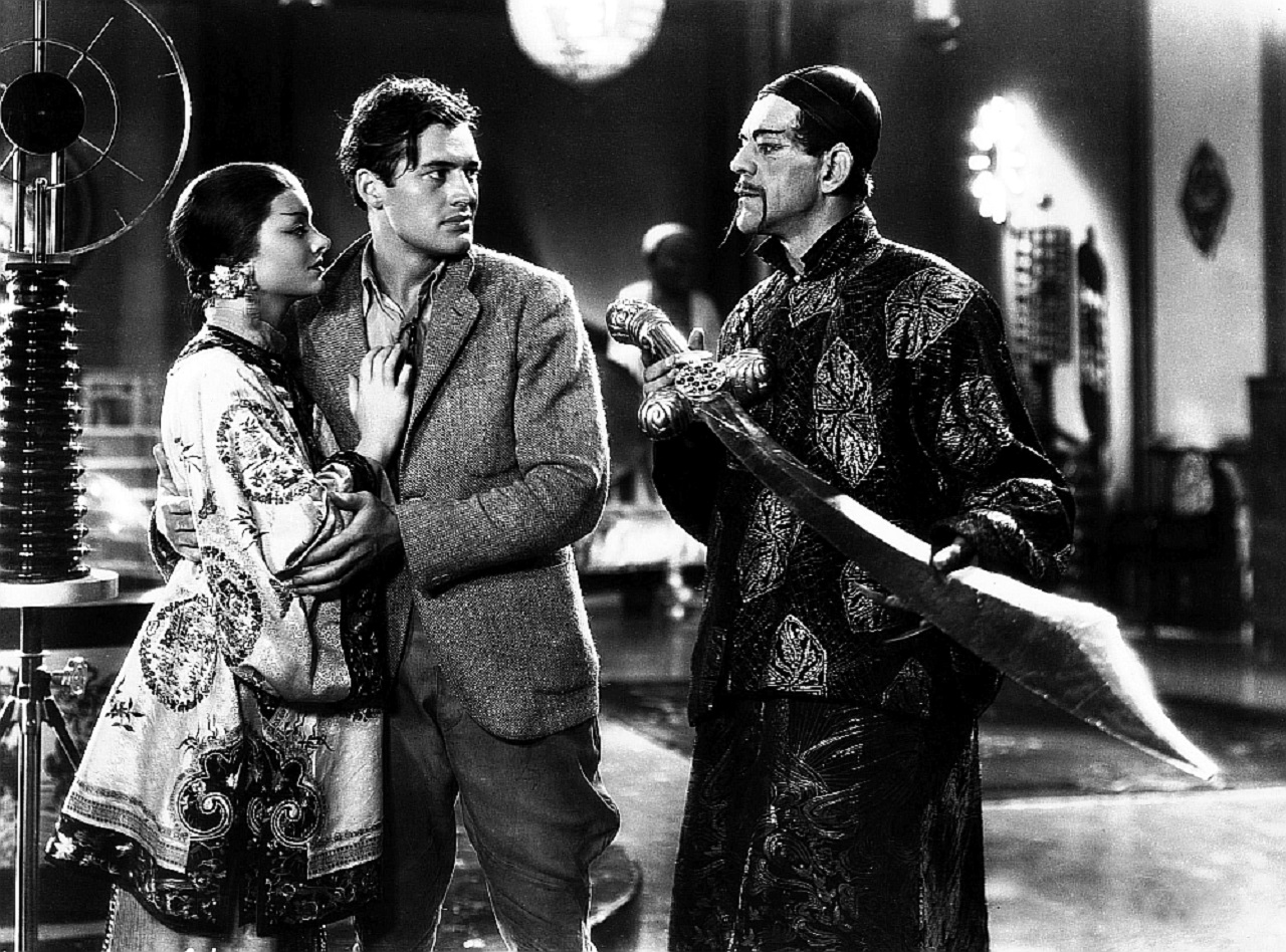 Charles Starrett protects Fah Lo See (Myrna Loy) from Fu Manchu (Boris Karloff) in The Mask of Fu Manchu (1932)