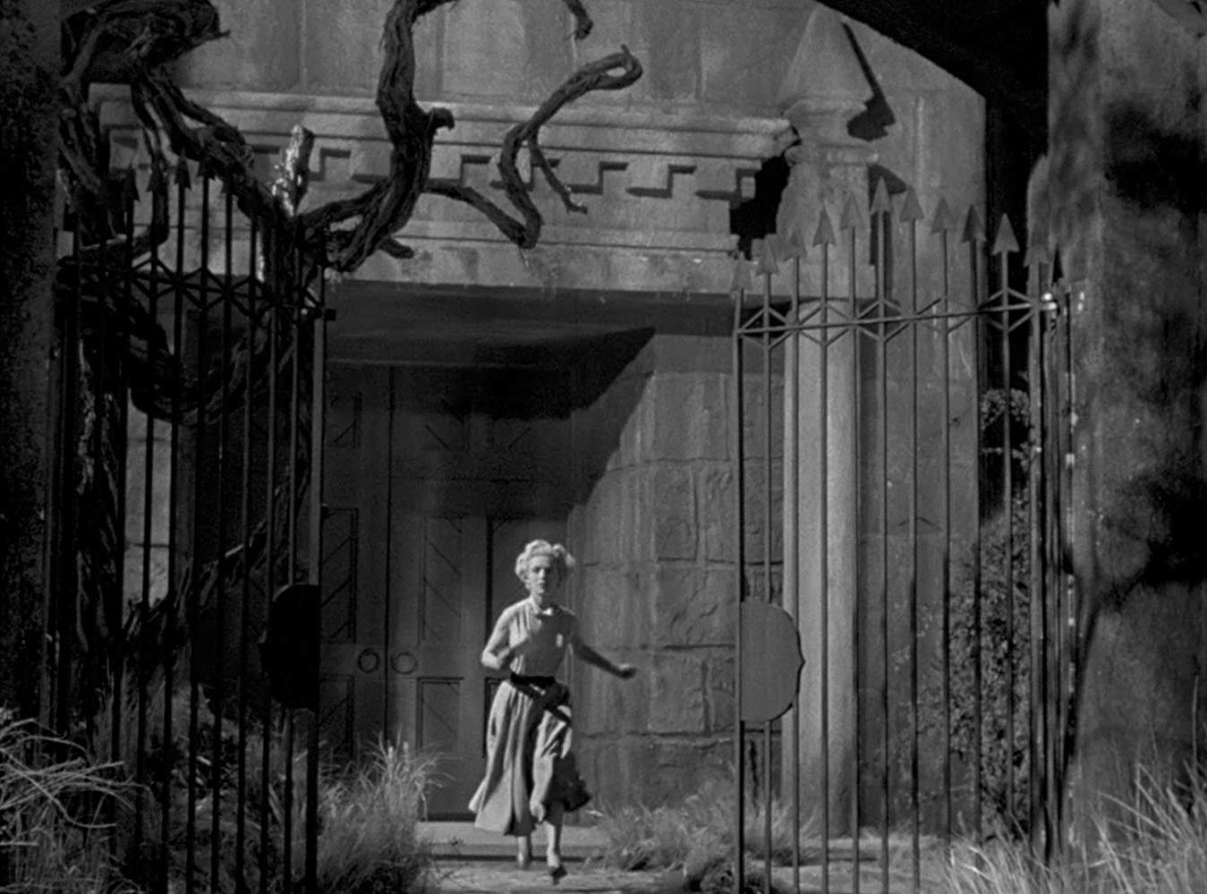 Veronica Hurst runs for the gates of Castle Craven in The Maze (1953)