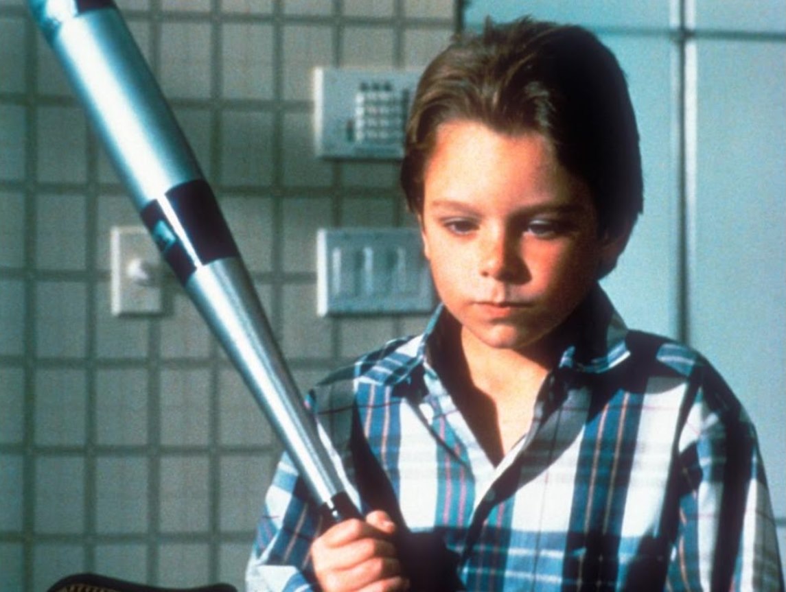 Brian Bonsall as Mikey with baseball bat