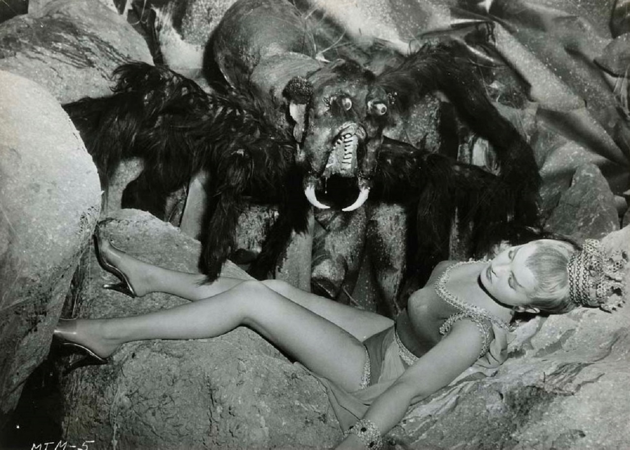 A moon woman under threat by the giant spider in Missile to the Moon (1958)