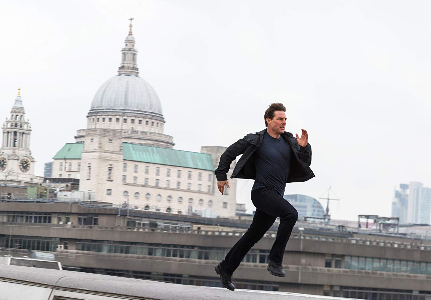 Ethan Hunt (Tom Cruise) back in action in a furious chase across the rooftops of London in Mission: Impossible - Fallout (2018)