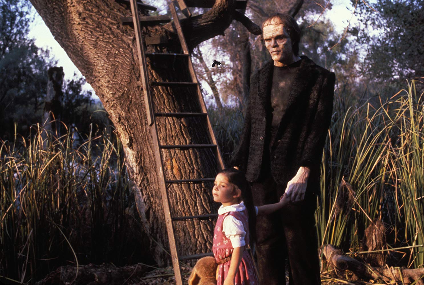 Young Phoebe (Ashley Bank) befriends the Frankenstein monster (Tom Noonan) in The Monster Squad (1987)