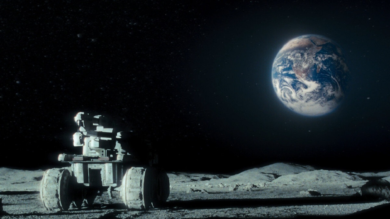 Buggy on The Moon's surface and Earth overhead in Moon (2009)