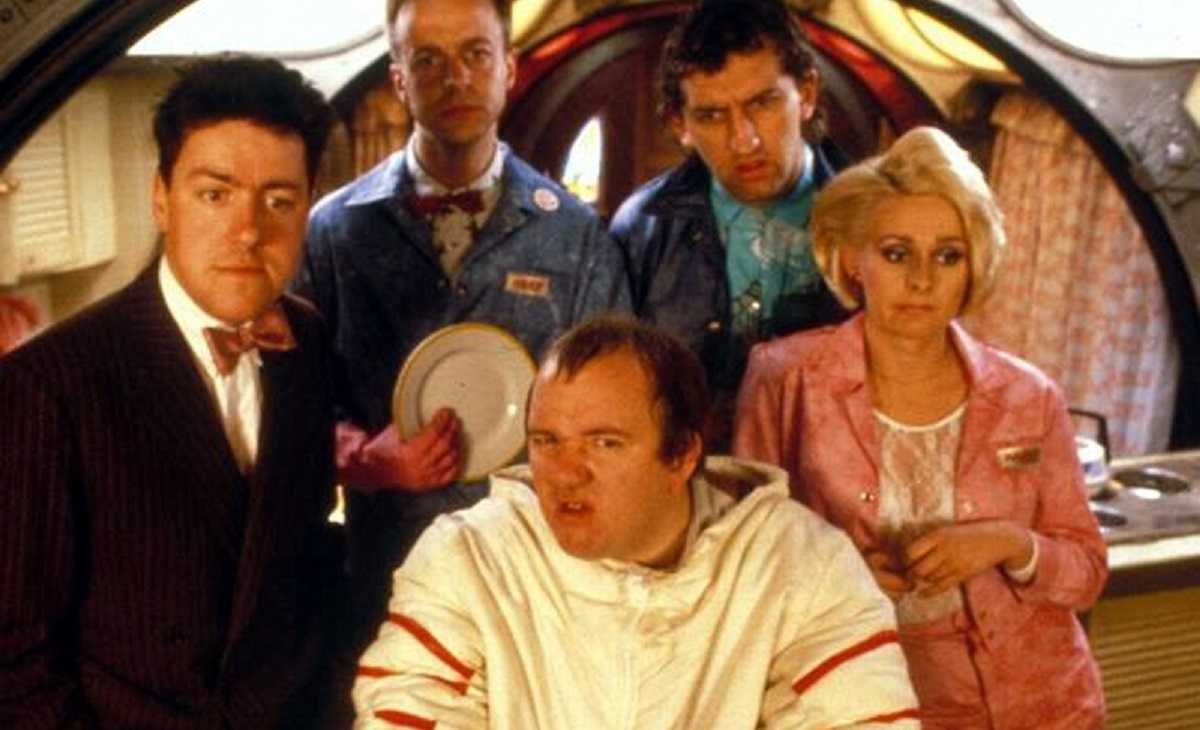 Griff Rhy-Jones, Mel Smith and the morons Paul Brown, Jimmy Nail and Joanne Pearce in Morons from Outer Space (1985)