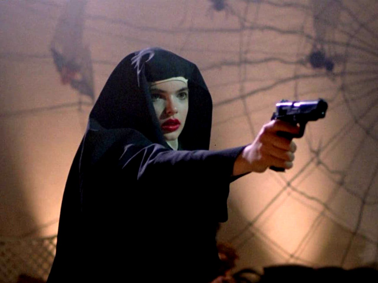 Zoe Tamerlis as Thana wielding a gun while dressed as a nun in Ms 45 (1981)