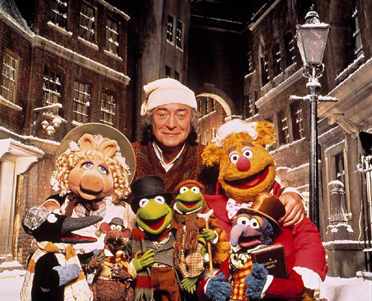 Scrooge (Michael Caine) surrounded by The Muppets in The Muppet Christmas Carol (1992)