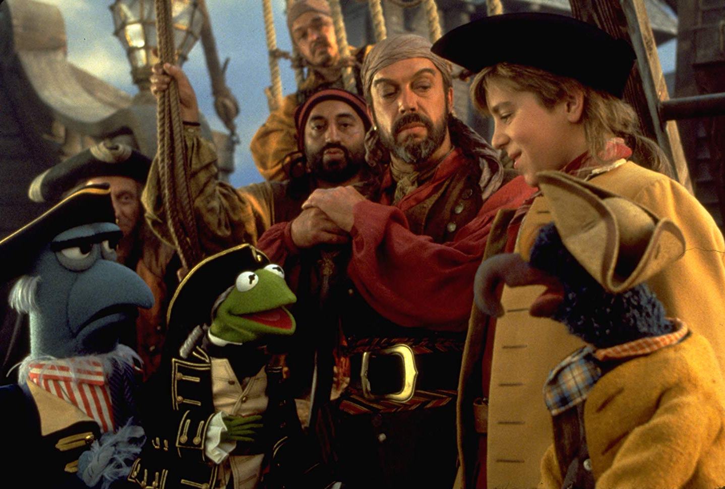 The Muppets with Long John Silver (Tim Curry) and Jim Hawkins (Kevin Bishop) in Muppet Treasure Island (1996)