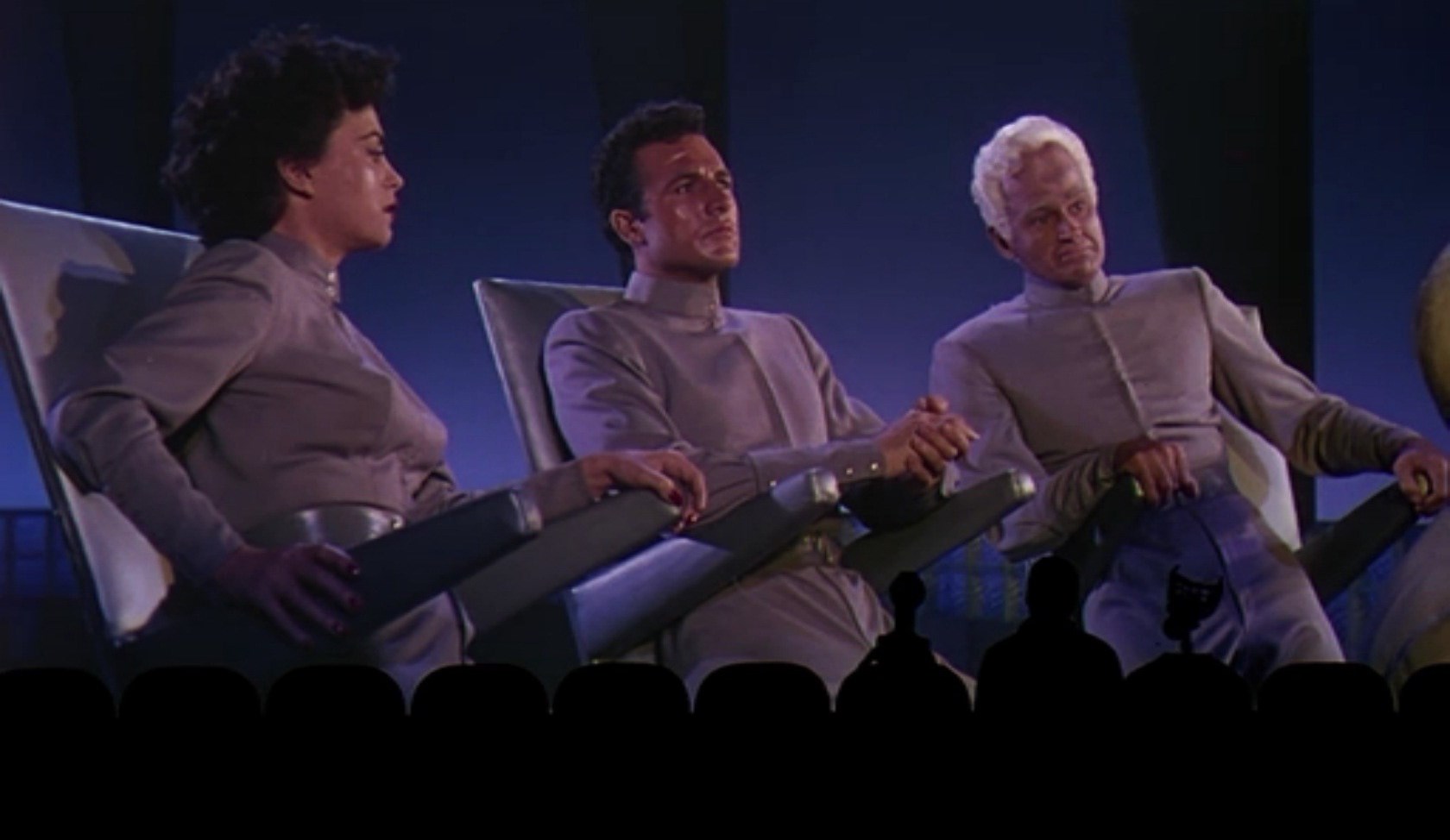 (l to r) Tom Servo (voiced by Kevin Murphy), Mike Nelson and Crow T. Robot (voiced by Trace Beaulieu) sit down to make fun of This Island Earth in Mystery Science Theater 3000: The Movie (1996)