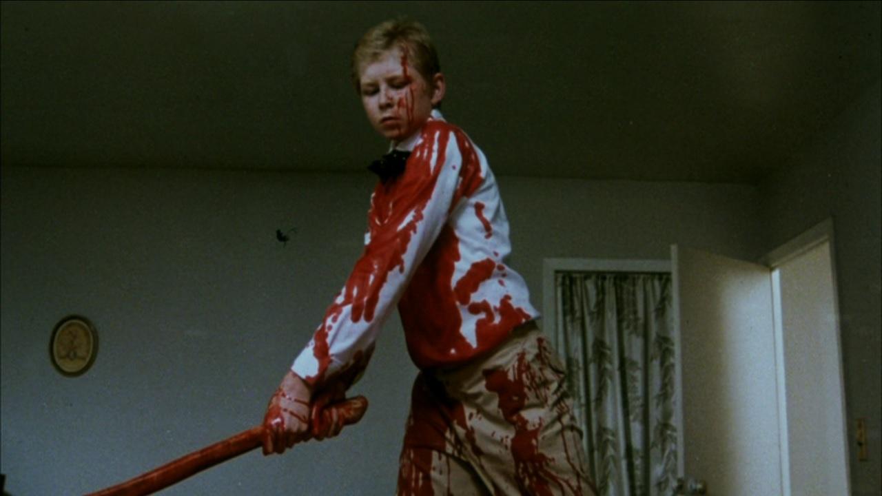 Young George (Scott Praetorius) hacks his parents up with an axe in Nightmares in a Damaged Brain (1981)